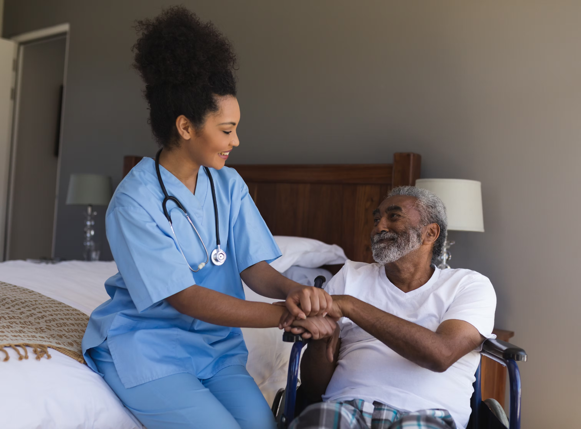 Caregiver holding the hand of an elderly resident with warmth and trust