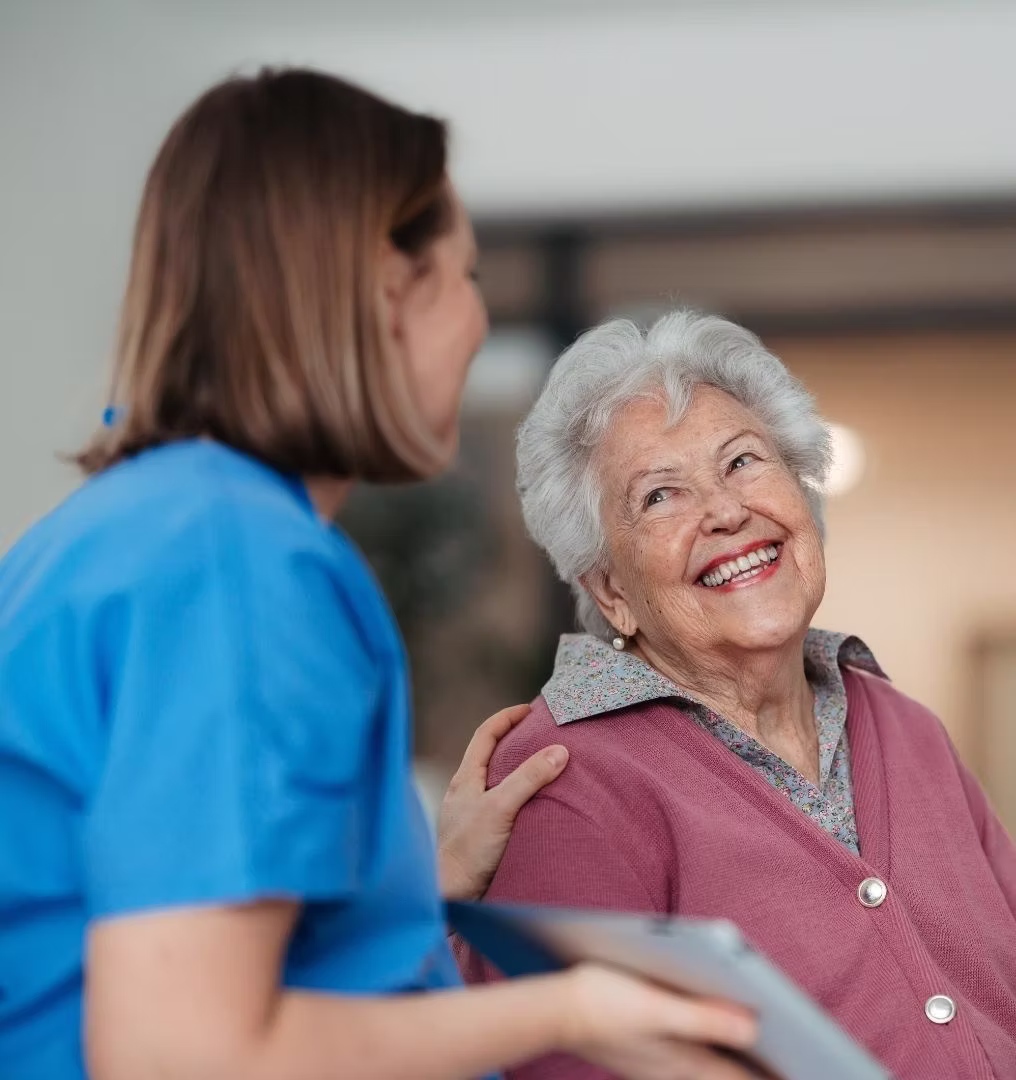 A laughing resident with their caregiver